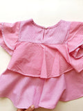 The back of the red and white striped children's shirt.