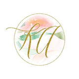 Photo of KimArt Designs logo, which is watercolor pastel flowers with "KA" in glittery gold script in a circle frame.